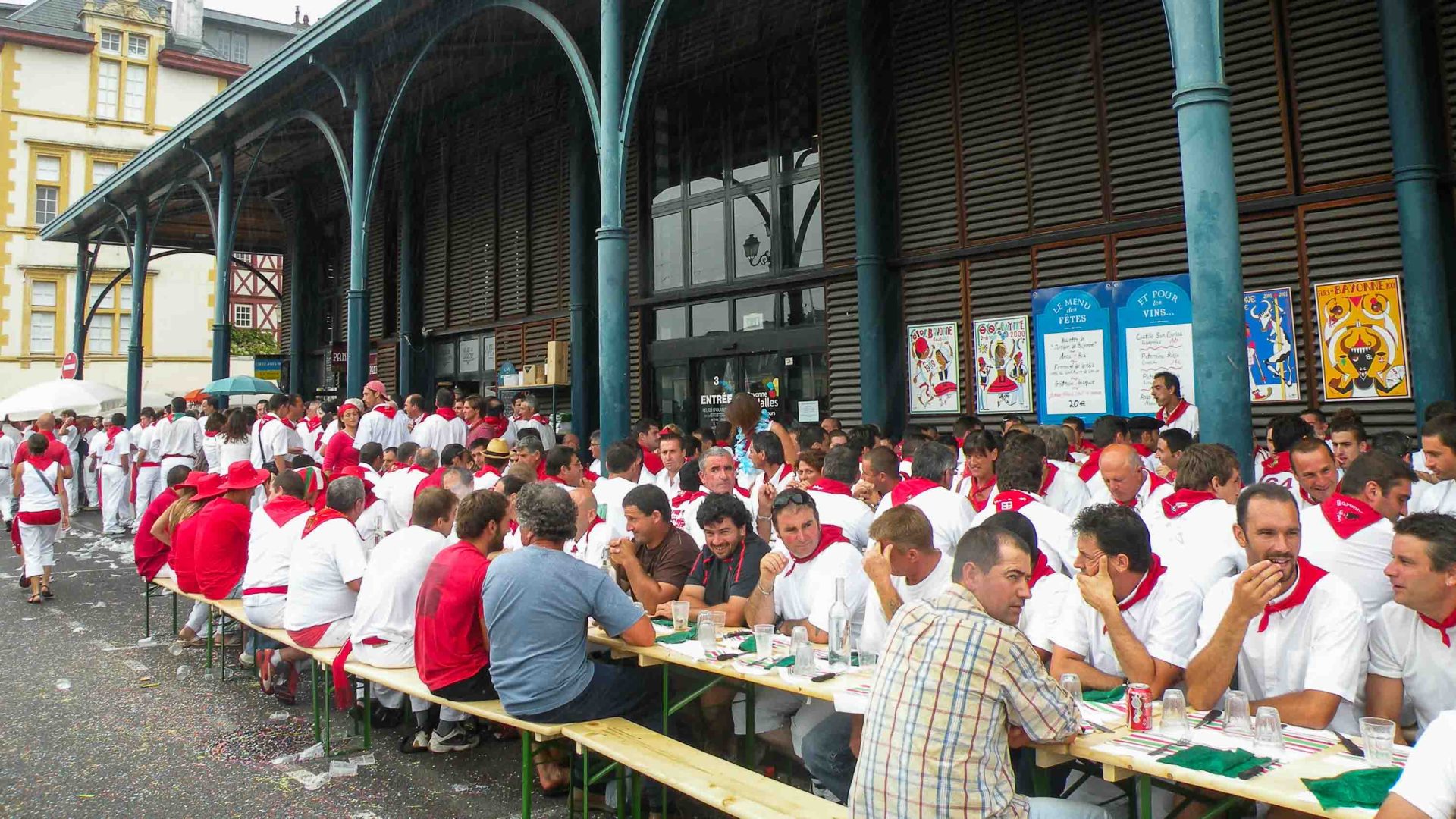 Long tables of people in red and white clothing.