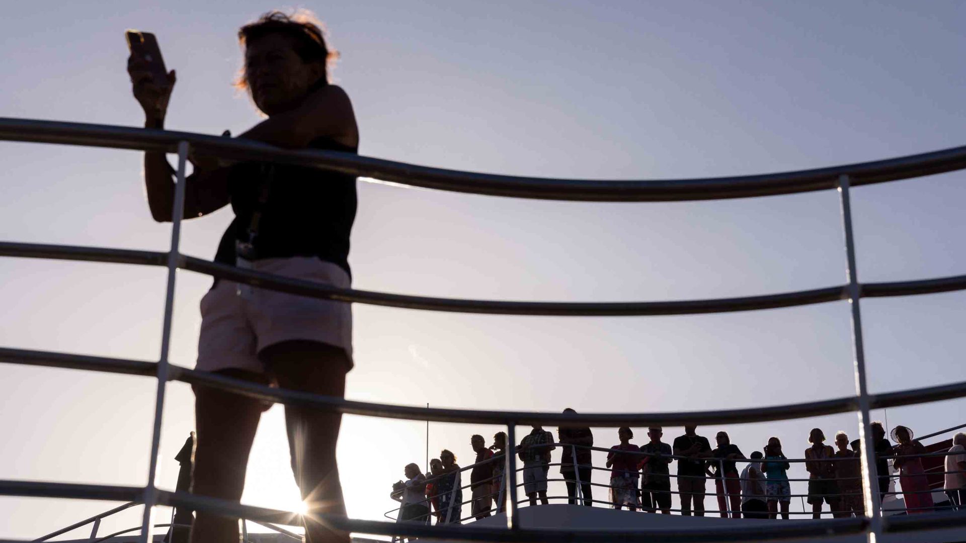 Silhouettes of passengers on the deck of the Aranui.