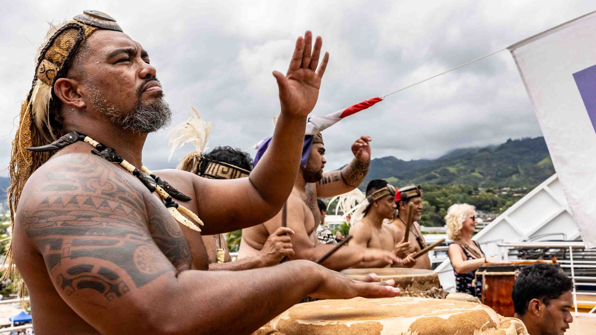 Musicians doing the haka on the deck of the Aranui welcome visitors.