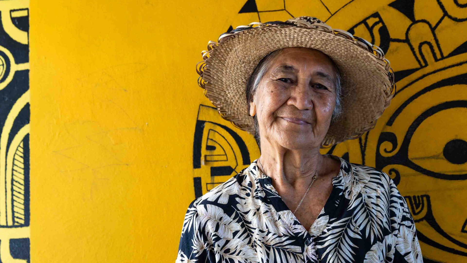 A portrait of a woman against a yellow background.