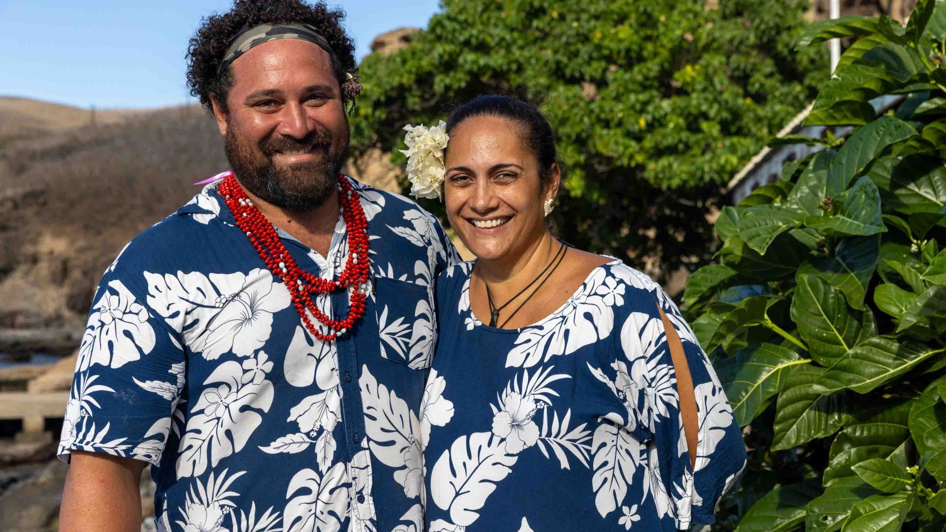 A portrait of a man and woman smiling together.