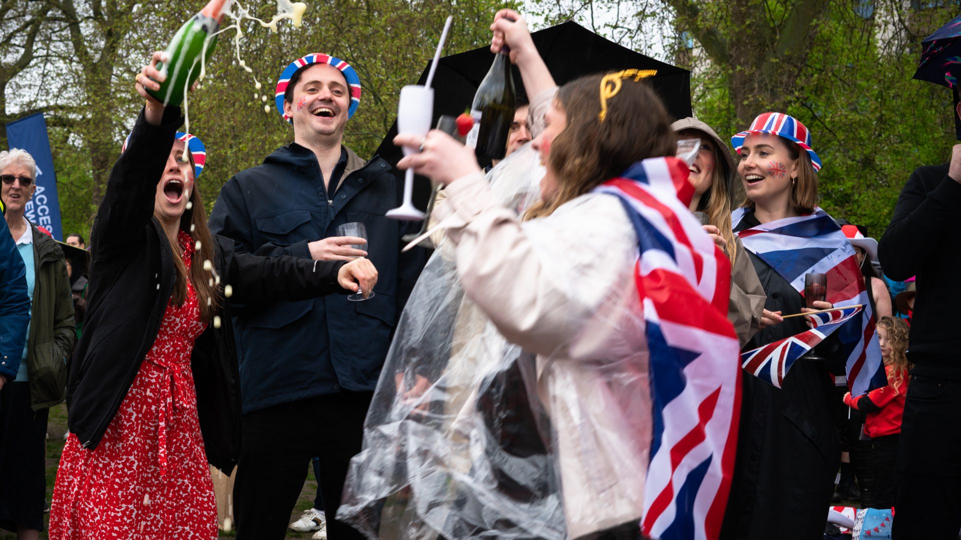 A group of people toasting the event in the park.