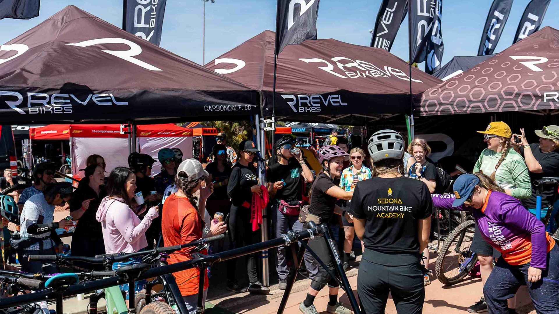 Mountain bike riders congregate at a festival.