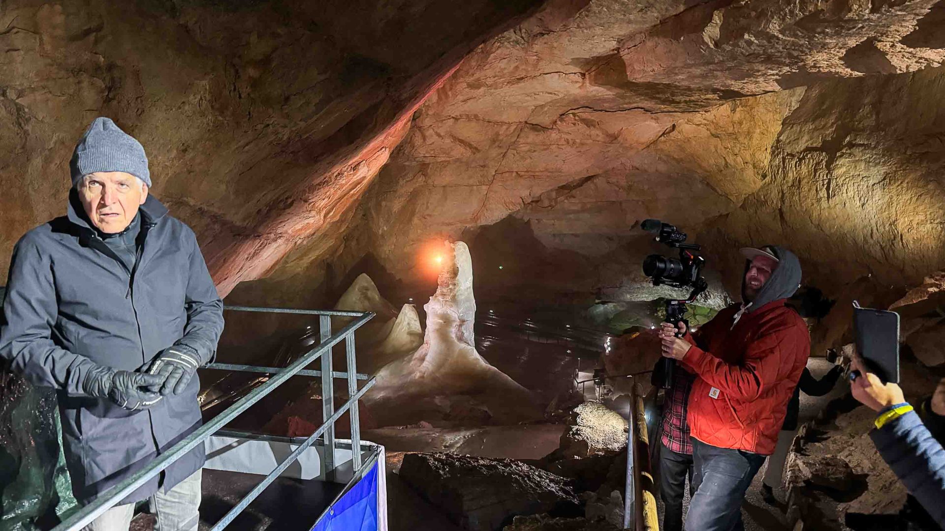 Bill is photographed by others while standing in a cave.