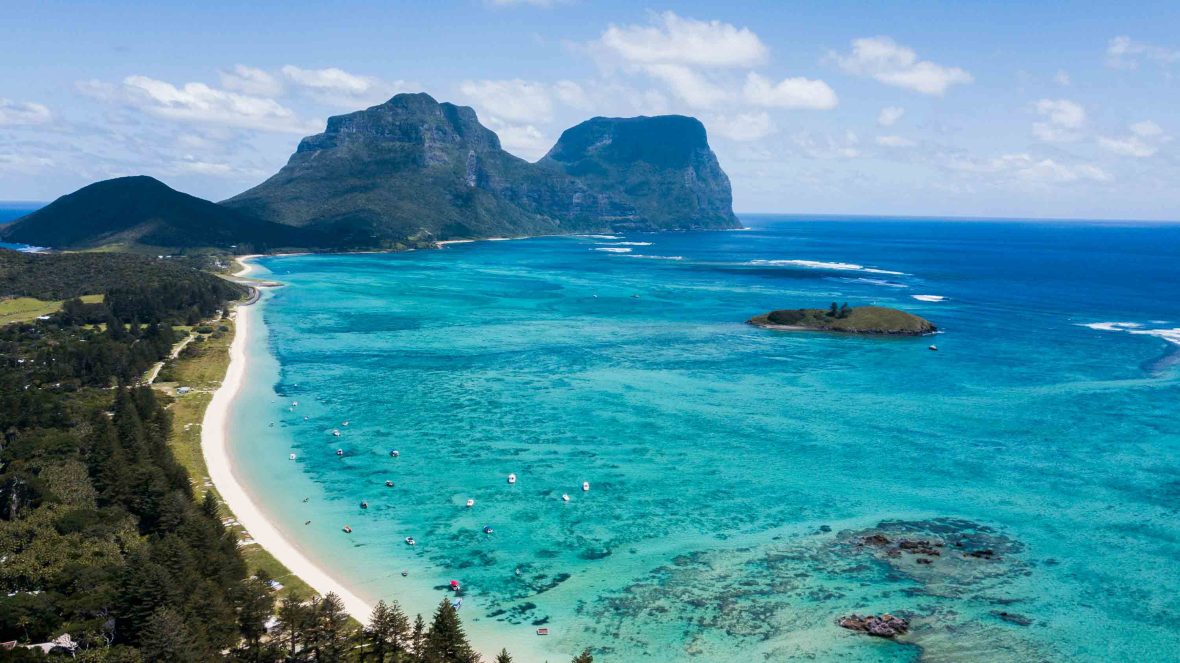 Turquoise waters, rocky outcrops and a sandy beach.