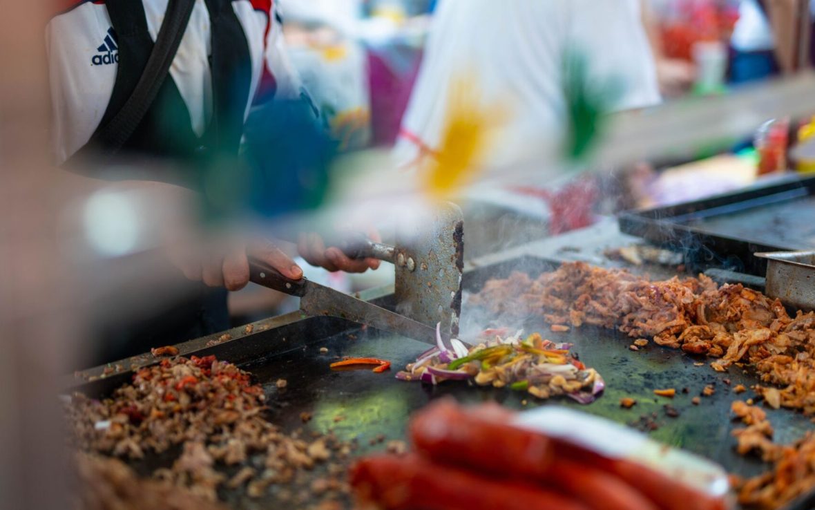 meat being cooked on large stove top in mexico