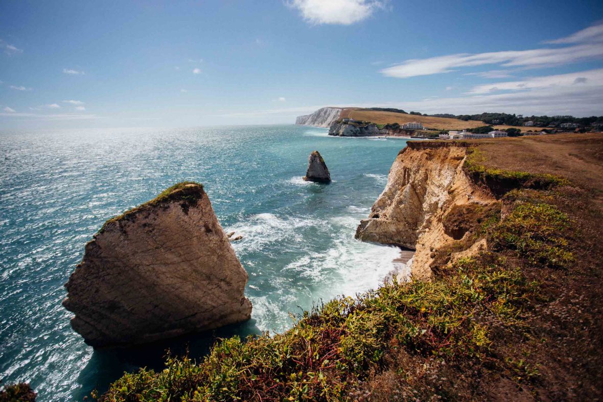 Rocky cliffs drop down to the ocean.