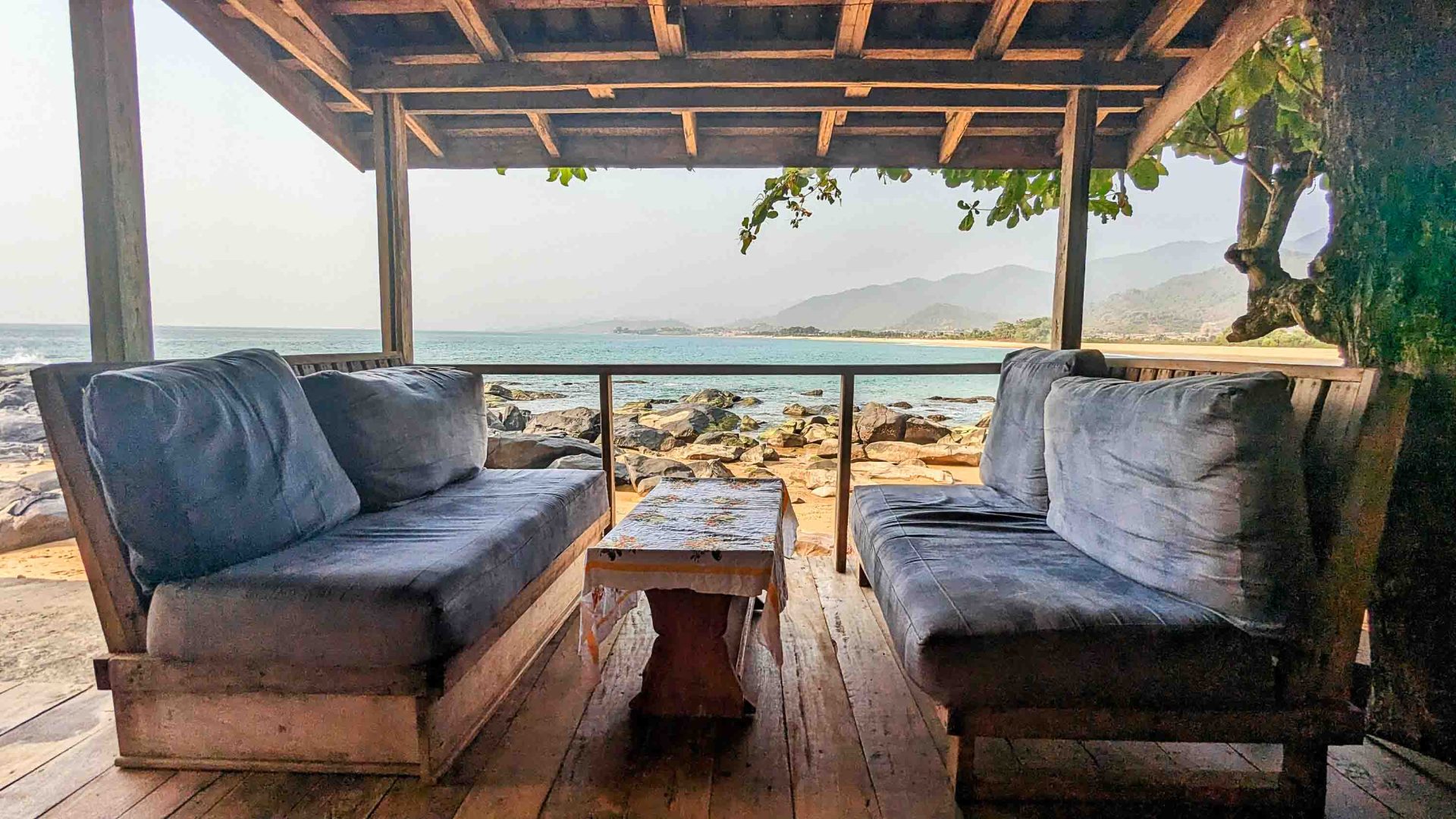 Couches on a deck overlooking the ocean.