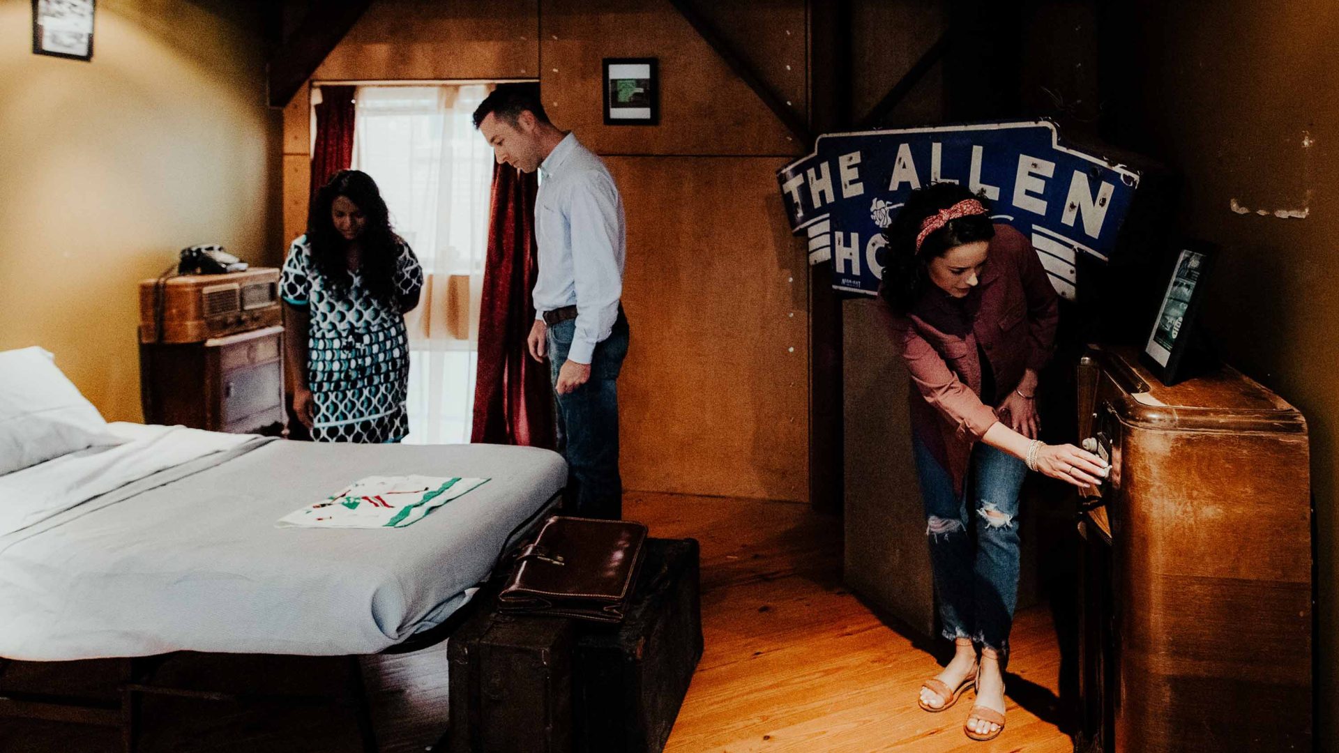 People explore a bedroom at the museum.