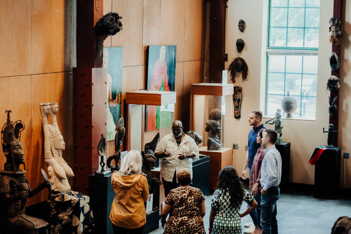 A tour guide talks to visitors to the museum.