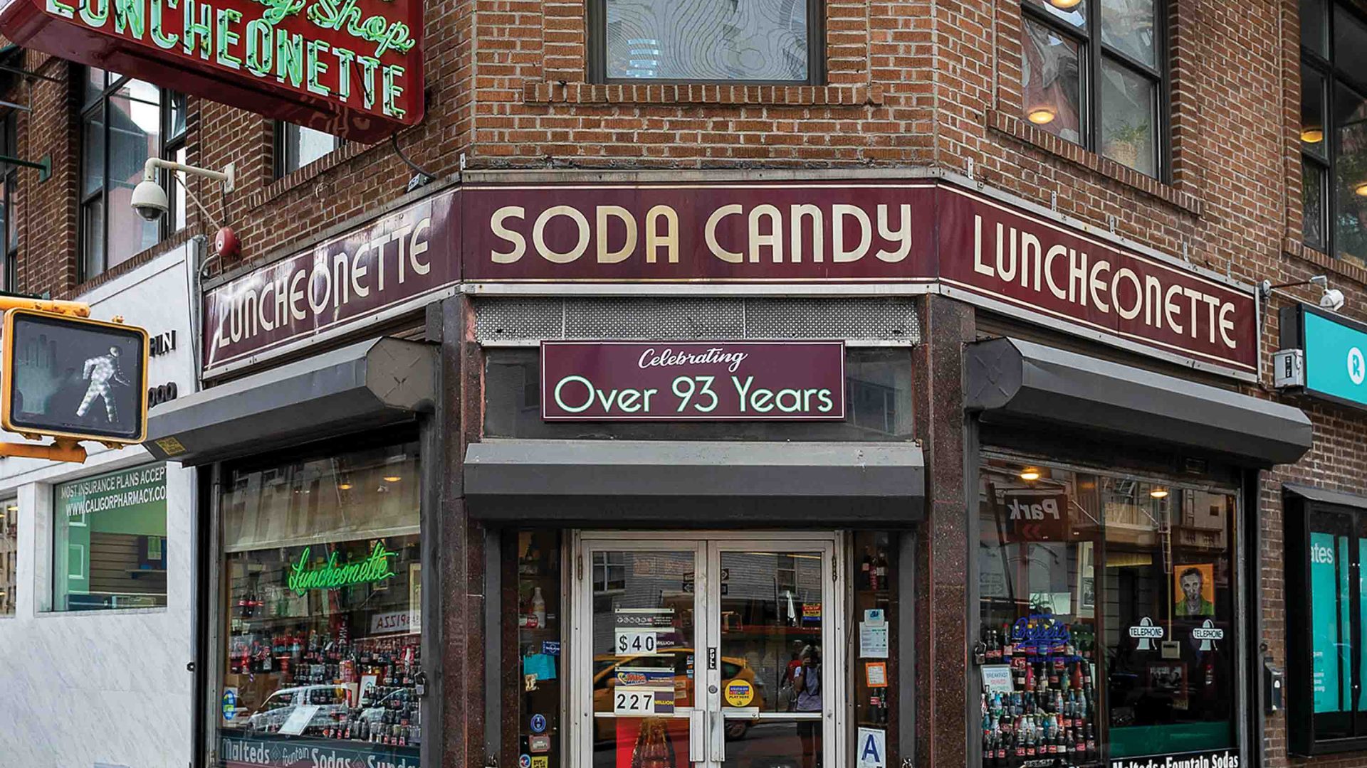 A store front with a neon sign.