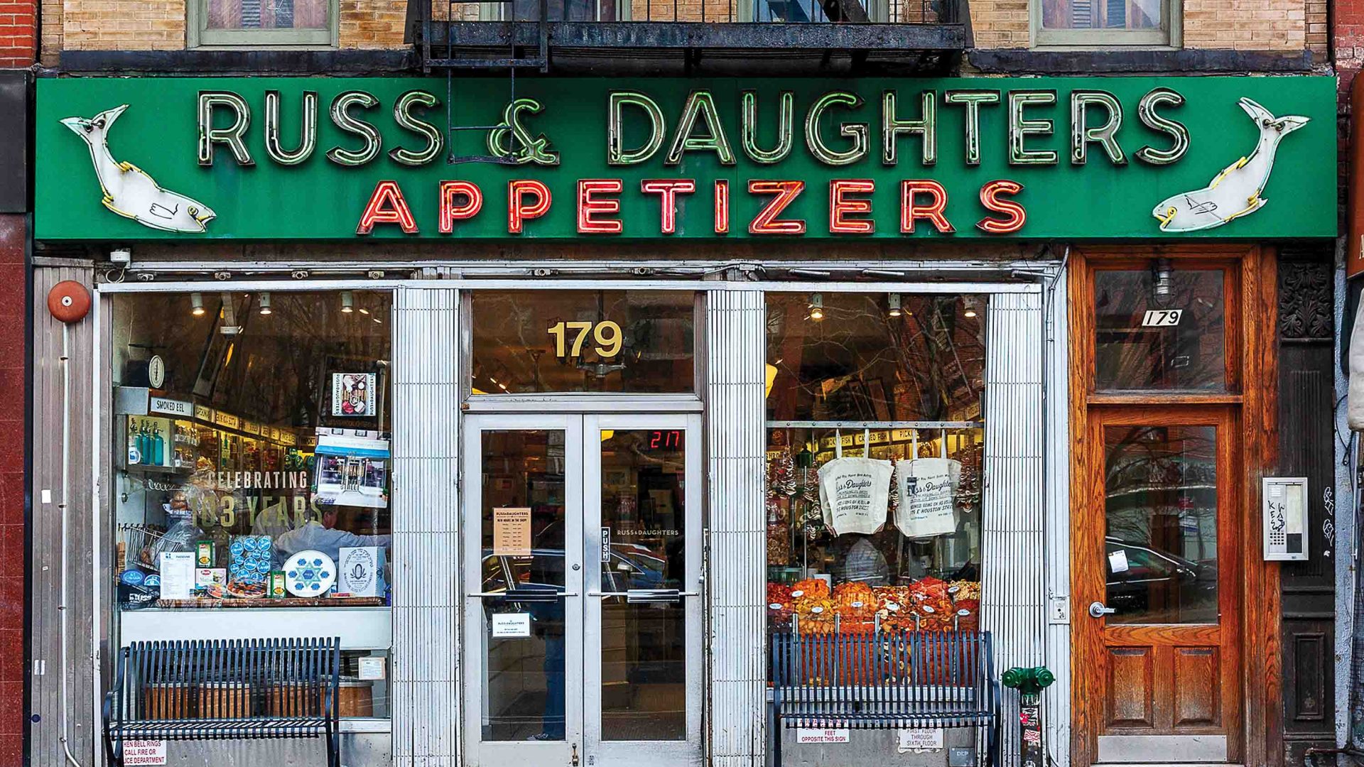 A storefront with green and red signage.