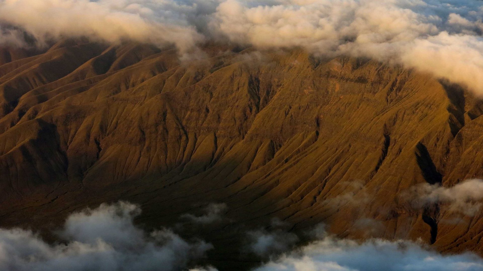 Clouds obscure part of the volcano.