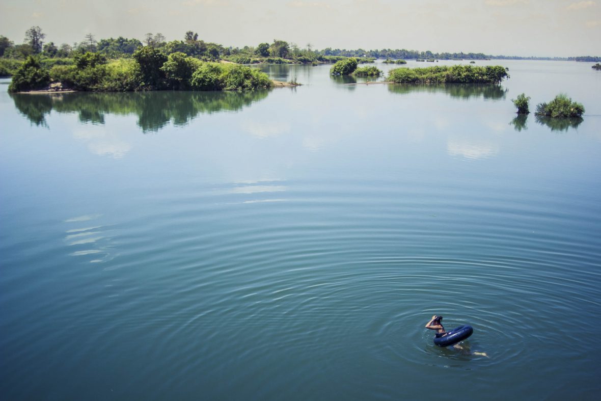 Tayla floats in the blue water in Laos.