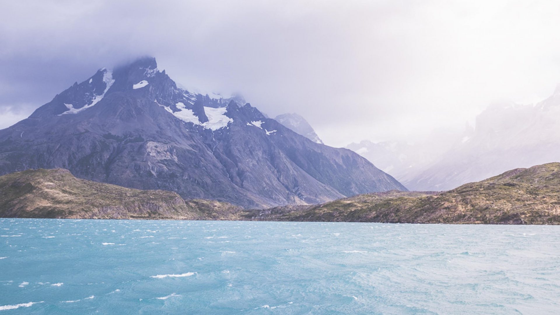 Turquoise water and snow capped mountains in Patagonia.