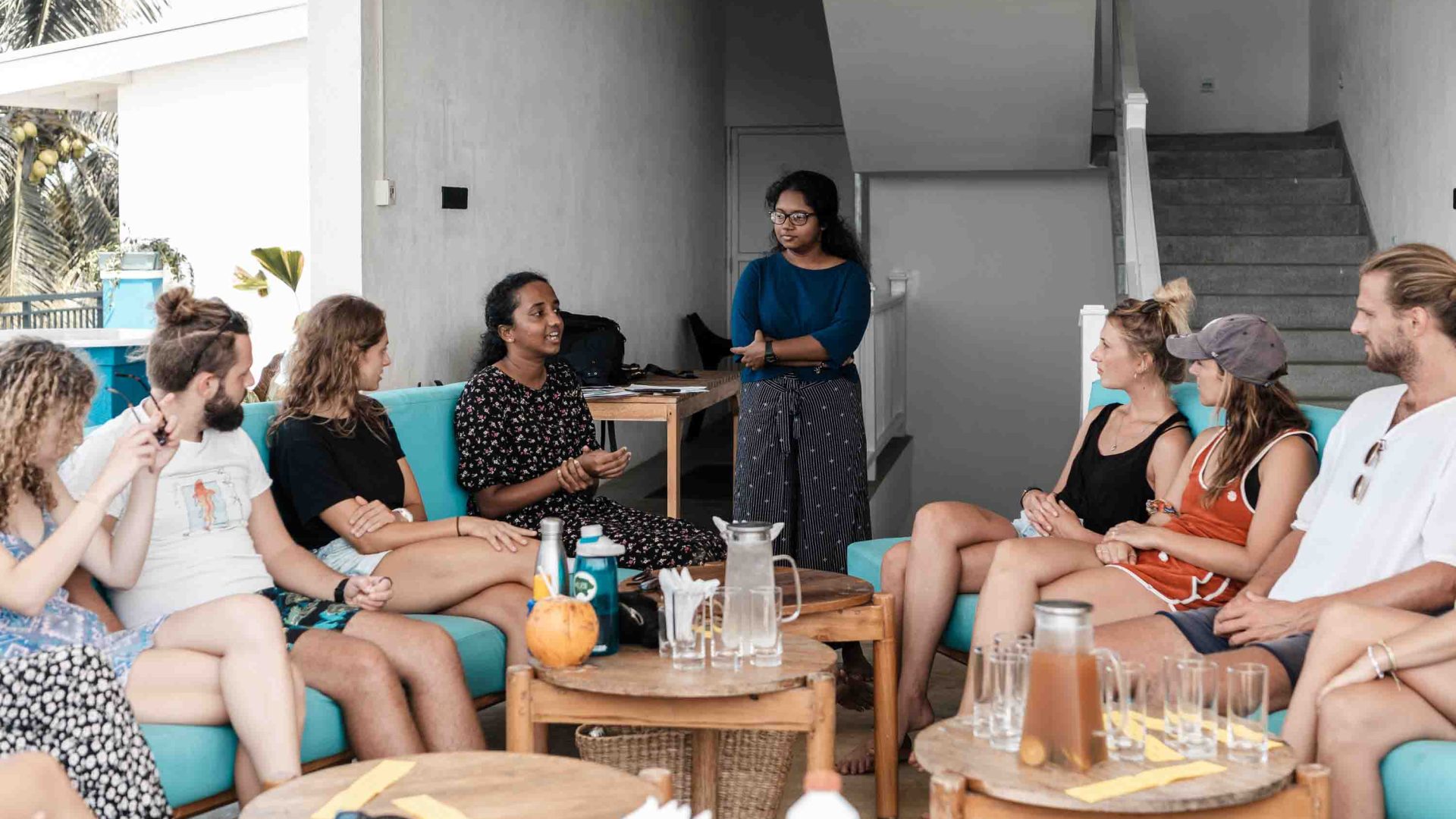 Women sit around and talk together.