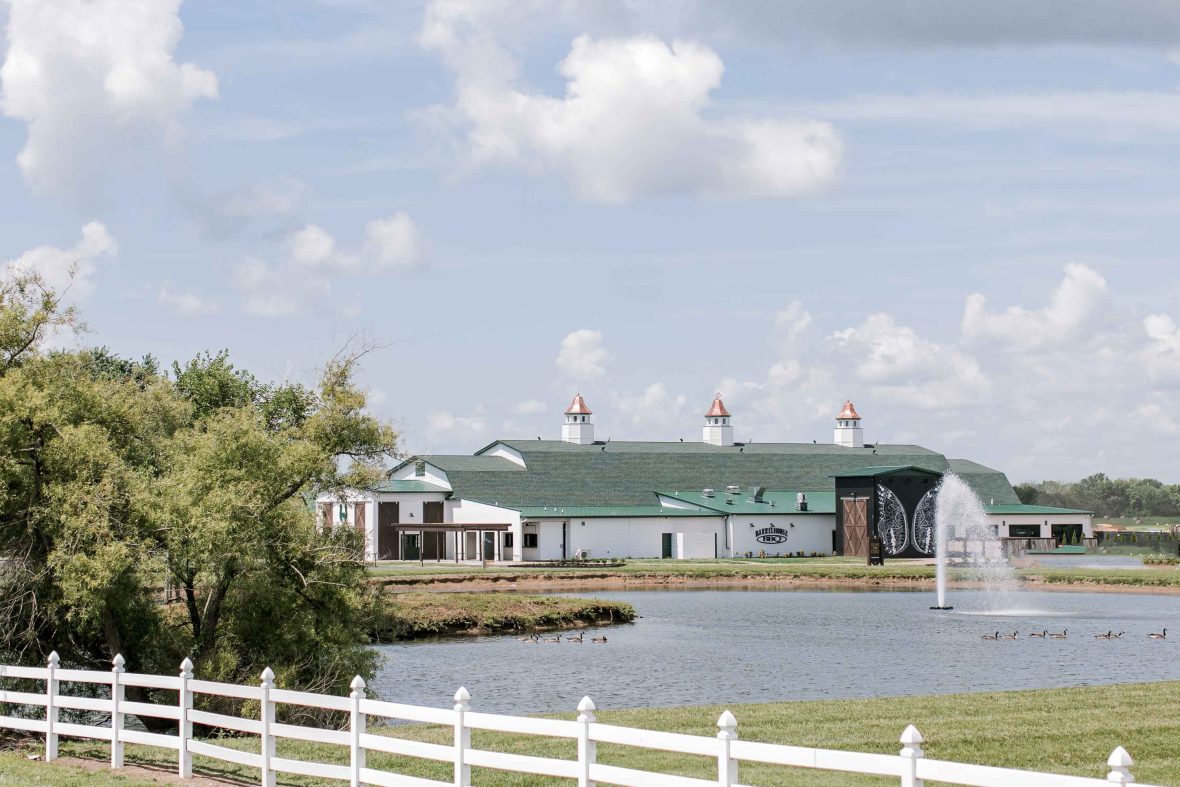 The distillery with a green roof and white walls.