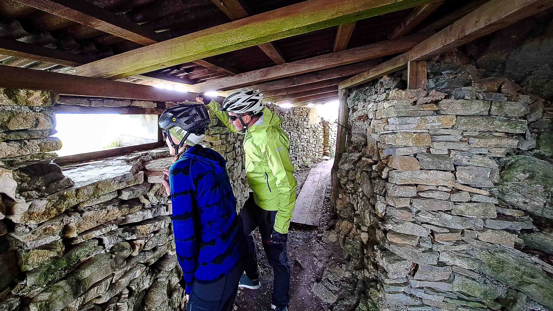 Cyclists look out from a bunker.