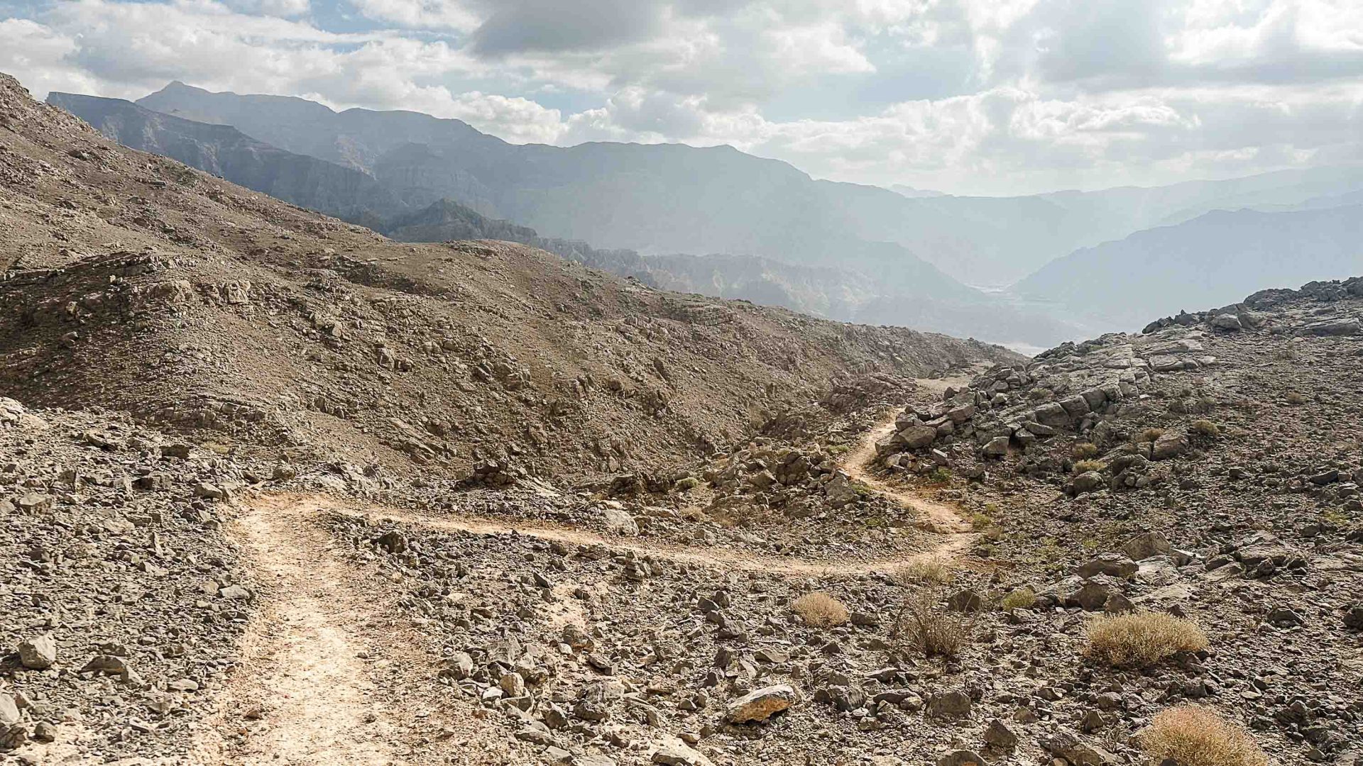 A trail leads through a rocky valley.