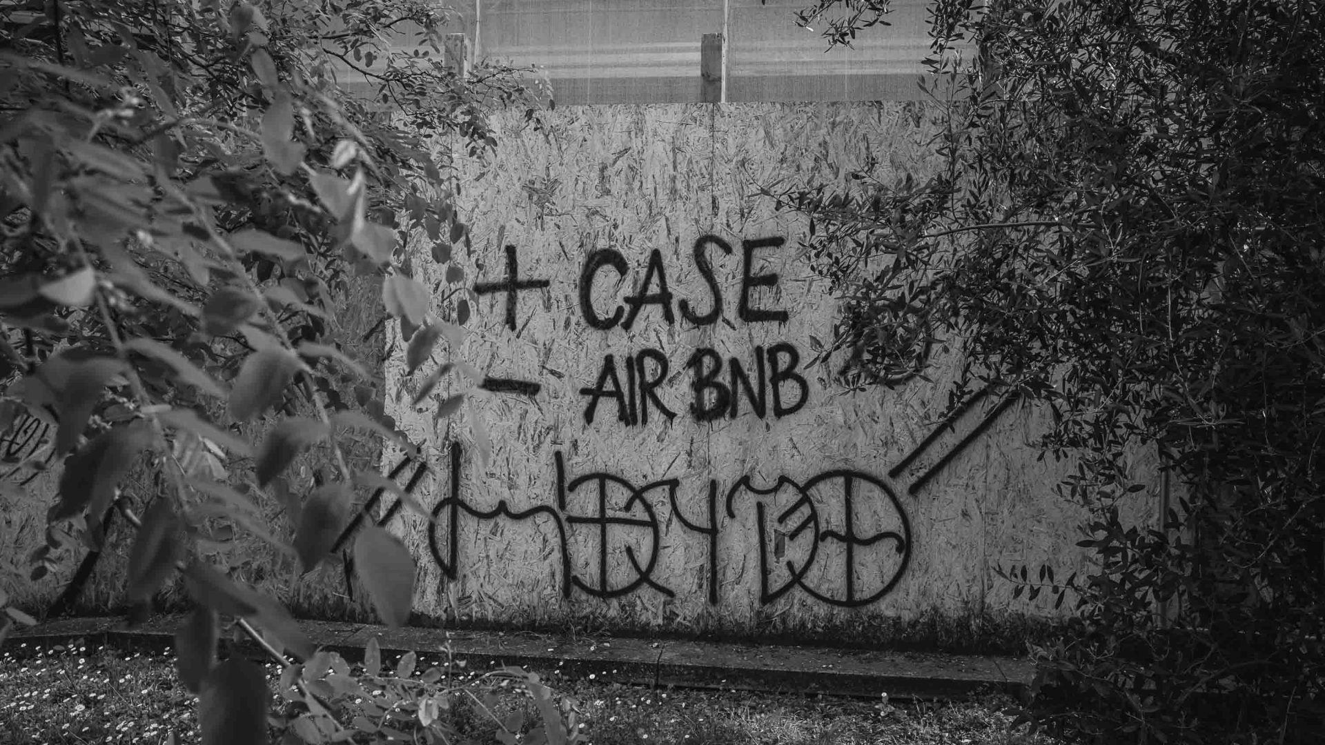 Graffiti on a wall says +case - air b&b