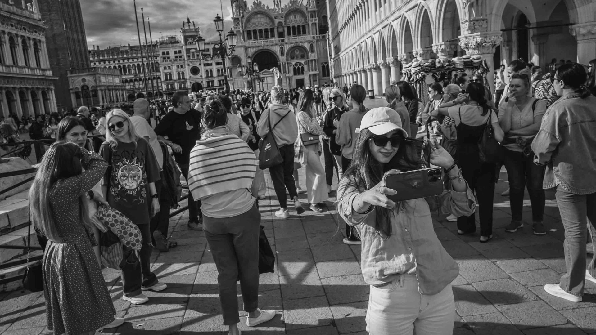 Tourists take photos and selfies at Piazza San Marco.