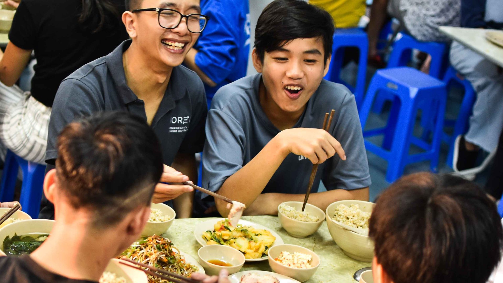 Trong and other young boys share a meal.