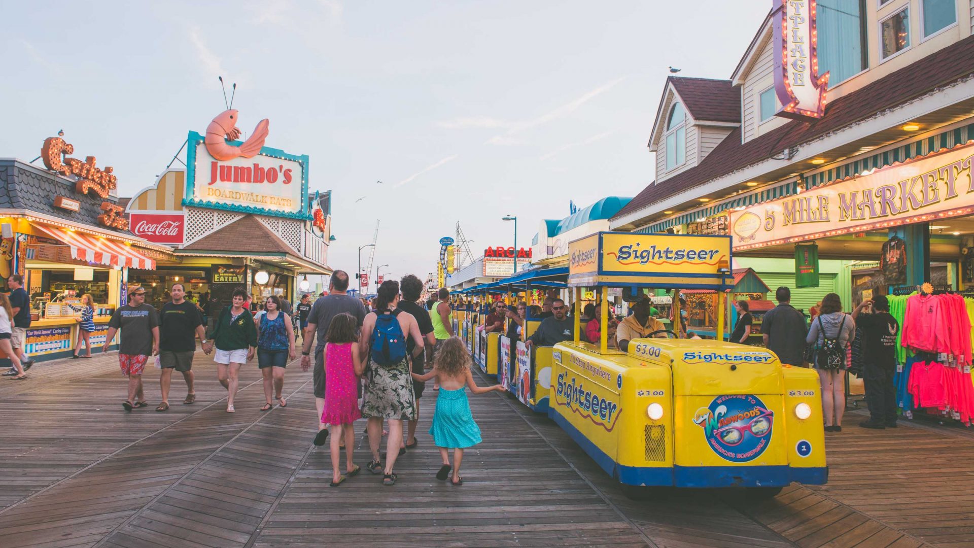 People stroll along the boardwalk at Wildwood at the end of the day.